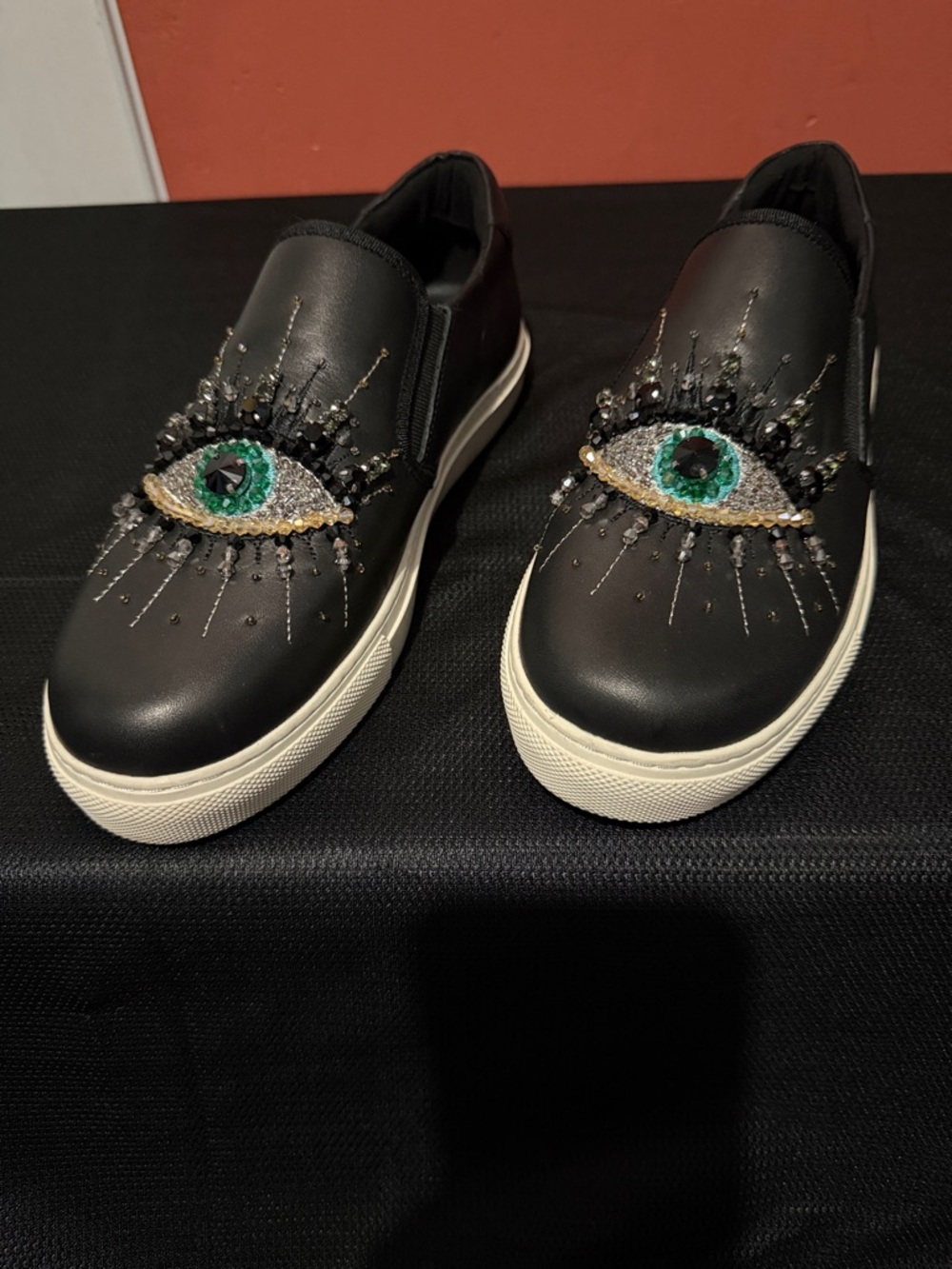 Kurt Geiger Black Slip-On Sneakers with Green Jeweled Eye Motif